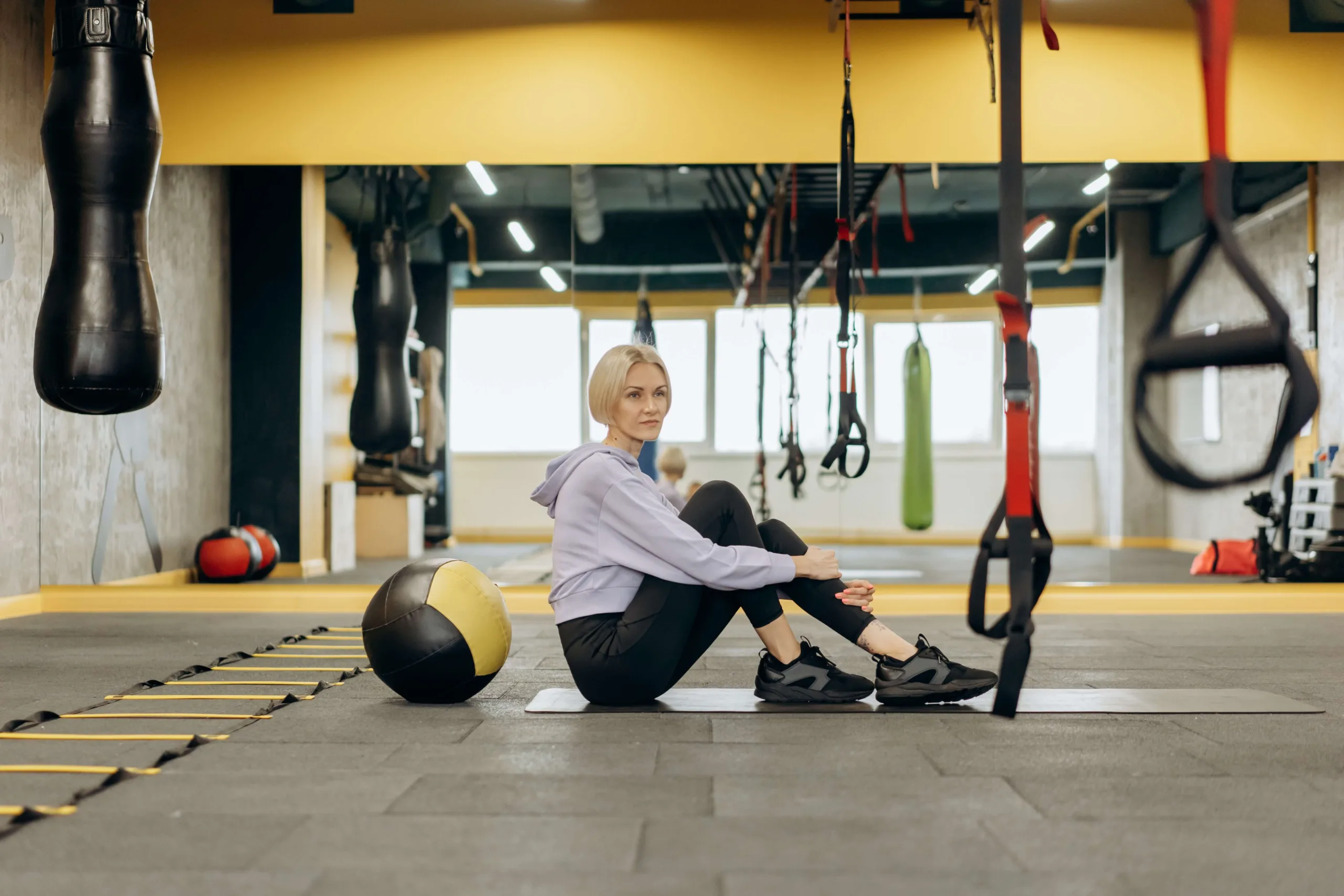 a personal trainer sitting in her studio before a client arrives